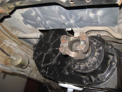 1991 Ford Bronco - Underside view of a vehicle's transfer case and driveshaft components.