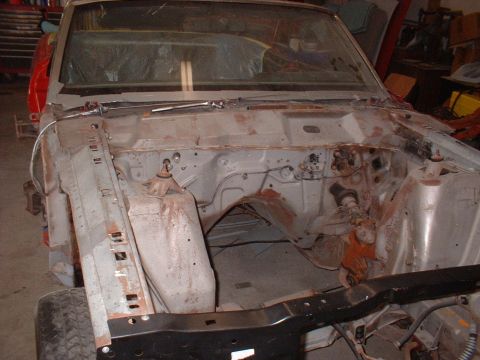 1970 Ford Torino - Engine bay of a car undergoing restoration, showing stripped components and frame structure.