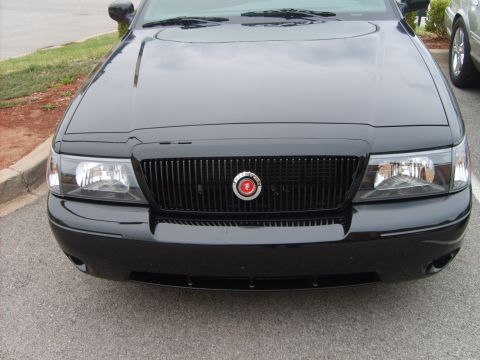 1993 Ford Crown Victoria - Front view of a black sedan, showing its grille and headlights.