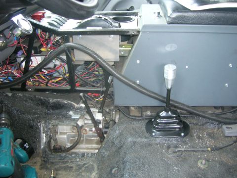 1996 Ford Bronco - The interior of a vehicle is shown with extensive wiring and transmission components exposed.