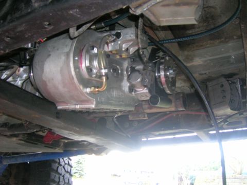 1996 Ford Bronco - Close-up of a vehicle's transmission and transfer case from below.