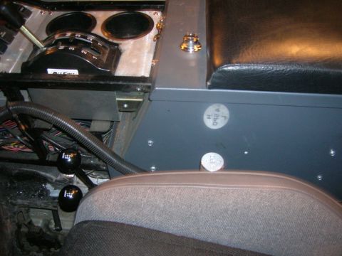 1996 Ford Bronco - The interior of a vehicle shows multiple gear shifters and seats.