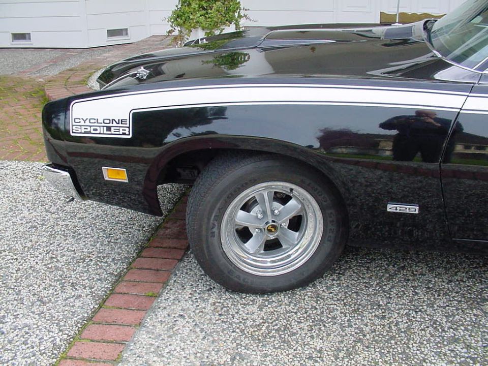 Black 1969 Mercury Cyclone Spoiler with white stripes and a '429' badge