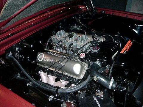 1963 Ford Galaxie - Close-up of a V8 engine triple carburetors and 'Thunderbird' valve covers.