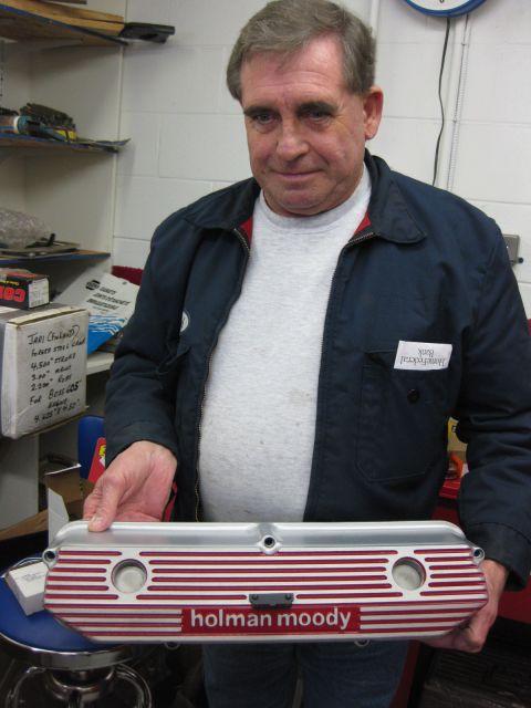 1969 Mercury Cyclone - A man holds a Holman Moody valve cover in a workshop setting.