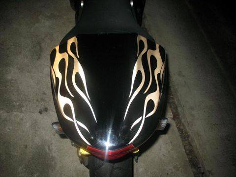 2008 Kawasaki Ninja R - Rear view of a black motorcycle fender adorned with gold flame graphics.