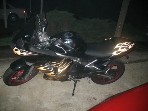 2008 Kawasaki Ninja R - This black motorcycle features flame decals on its side fairing and seat cowl, with red rims.