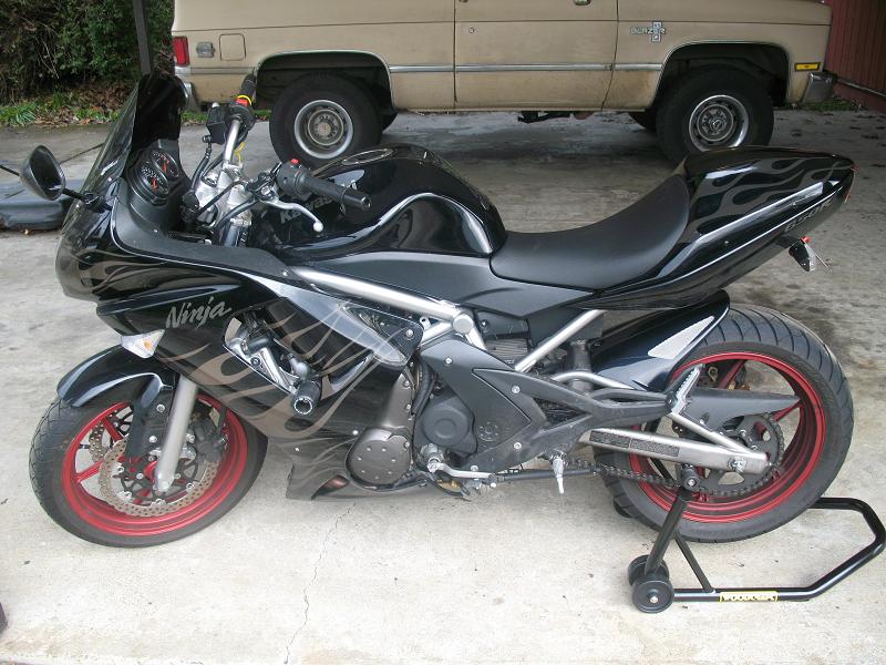 2008 Kawasaki Ninja R sportbike, black with flame decals, on a rear stand