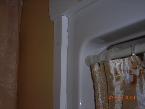 1984 Ford Bronco - A close-up view of a shower stall interior, showing a curtain and a date stamp.