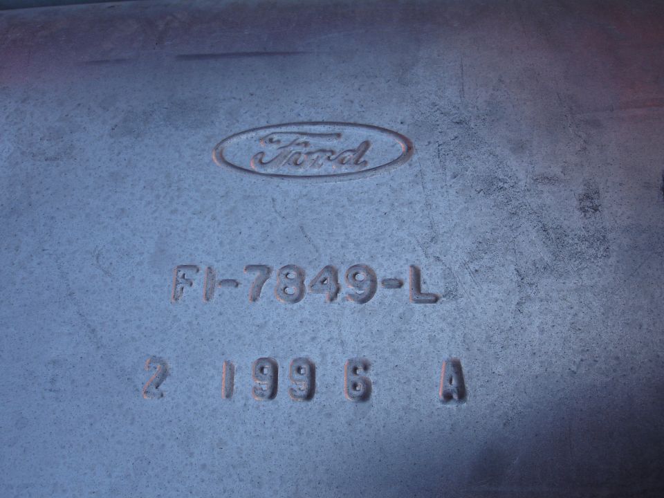 Metal part with embossed Ford logo and part numbers FI-7349-L and 2 199 6 A