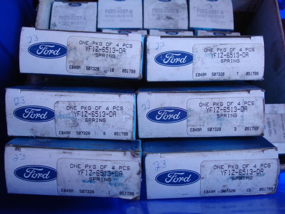 Stacked boxes of Ford Taurus valve springs, showing part numbers and the Ford logo.
