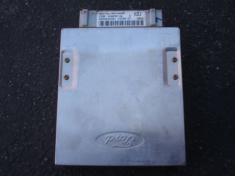 1993 Ford Taurus - A close-up view of an engine control module, likely an automotive part.