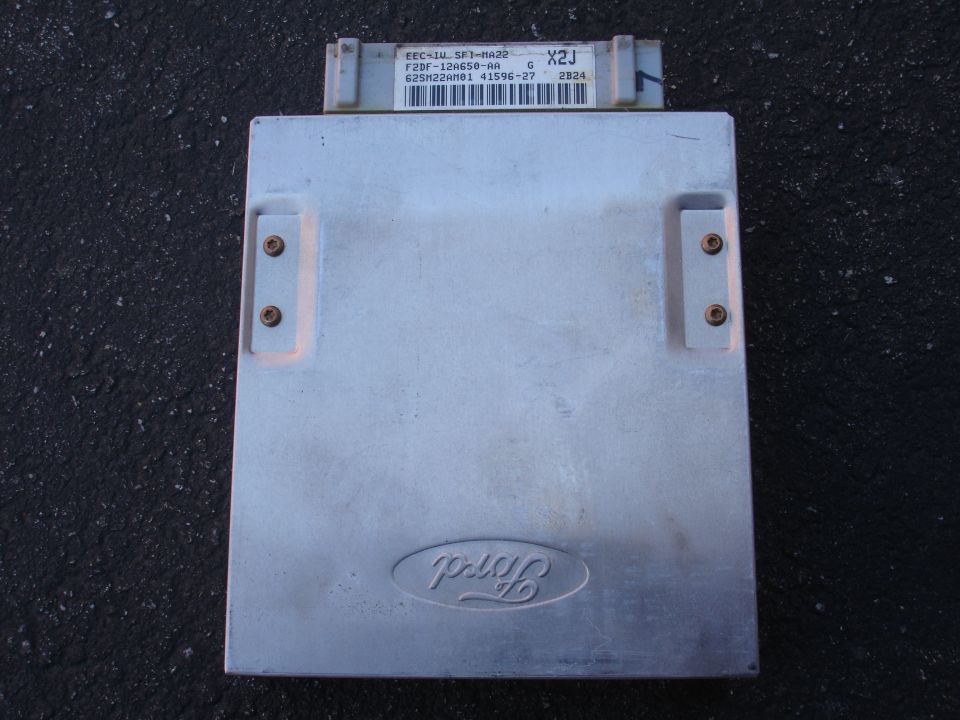 Engine control module with metal casing and visible connectors