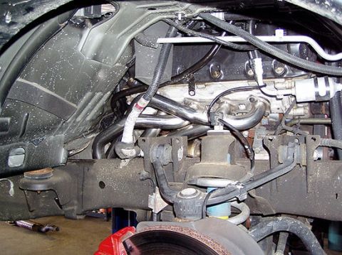 2007 Ford Mustang - Underbody photograph of engine plumbing and front suspension, not a technical document.