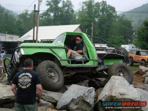 1979 Ford Bronco - Modified green truck navigates a rocky obstacle course with another vehicle visible.