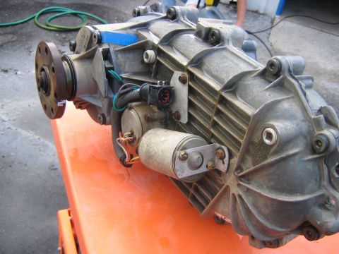 1992 Ford Bronco - Close-up of a vehicle transfer case, likely a Ford Bronco part, with visible wiring and actuators.