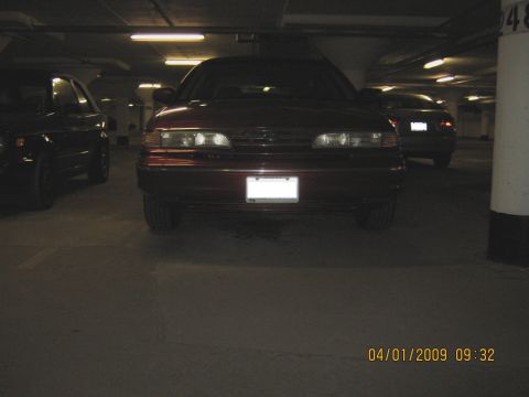 1997 Ford Crown Victoria - Front view of a 1997 Ford Crown Victoria parked in a dimly lit garage.