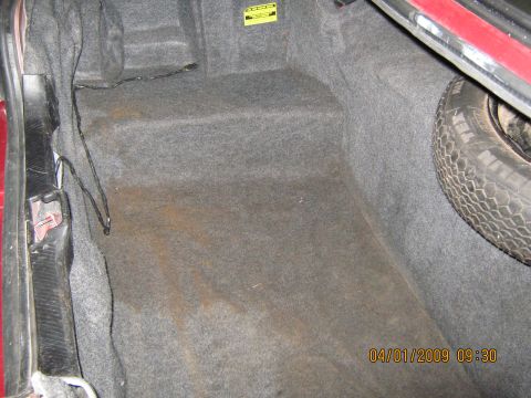 1997 Ford Crown Victoria - Interior view of a car's trunk, including the spare tire and visible wiring.