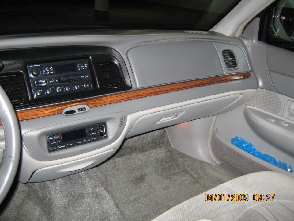 1997 Ford Crown Victoria interior dashboard with wood trim, radio, and air vents