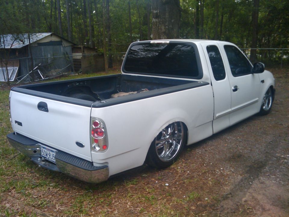 White 2000 Ford F-150 pickup truck, lowered with chrome wheels