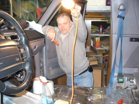 1994 Ford Bronco - Man working on the interior of a 1994 Ford Bronco, possibly doing repairs or modifications.