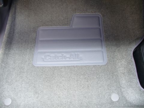 1994 Ford Bronco - A gray Catch-All floor mat is visible on the carpeted floor of a vehicle's interior.