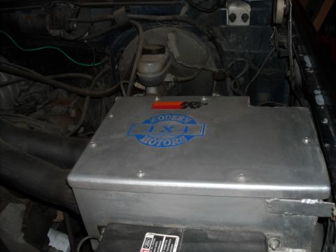 1989 Ford Bronco - Close-up of a vehicle's engine bay, a custom "TODERY 4X4 MOTORS" air intake system.