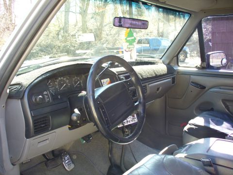 1994 Ford Bronco - Interior view of a 1994 Ford Bronco, with another vehicle seen outside.