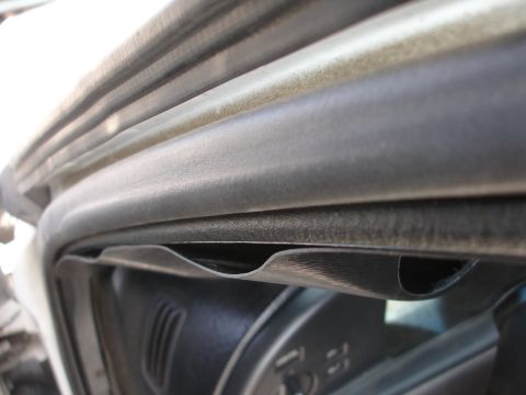 1993 Ford Taurus - Close-up of a car's interior door seal and surrounding trim.