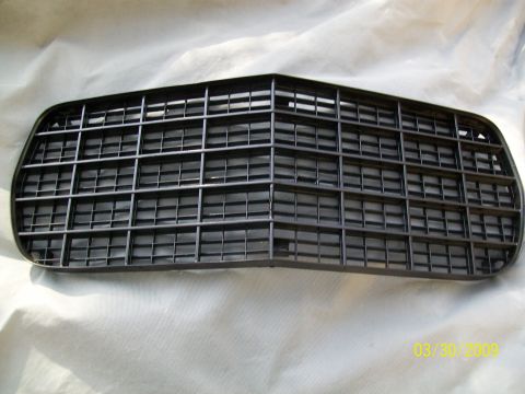 1972 Ford Ranchero - A black car grille is shown lying flat on a white surface.