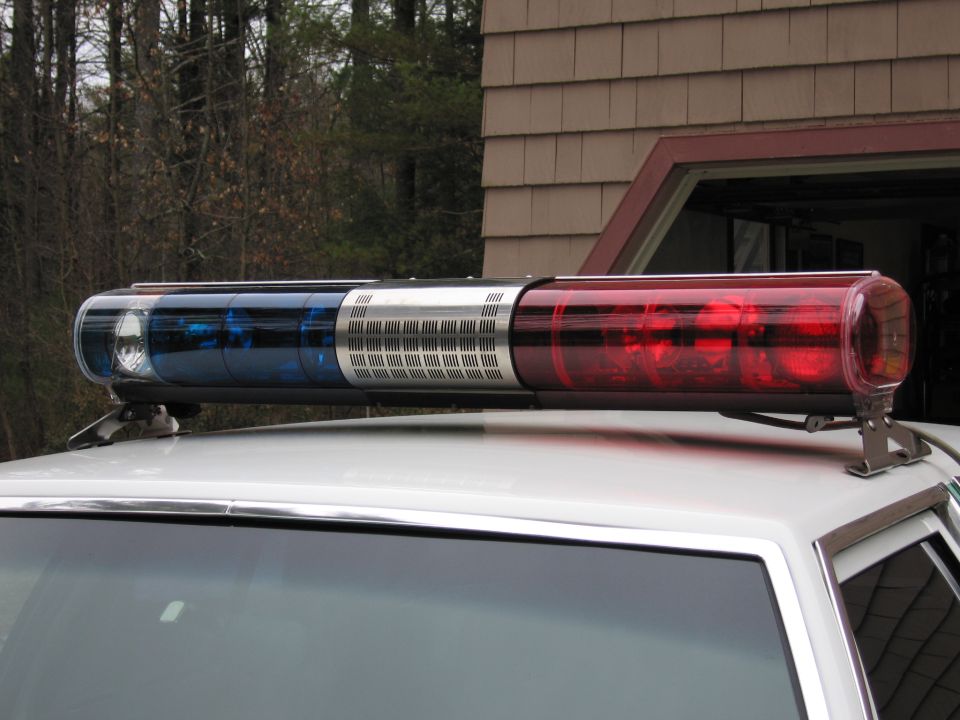 Close-up of red, blue and clear police roof light bar on a car
