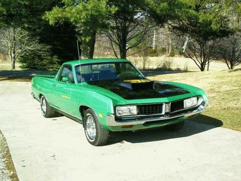 1971 Ford Ranchero - A green 1970 Ford Ranchero with a black hood and yellow Cobra decal is parked outside on a concrete driveway.