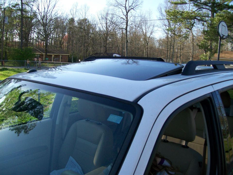 2008 Ford Escape side view showing sunroof and roof rack