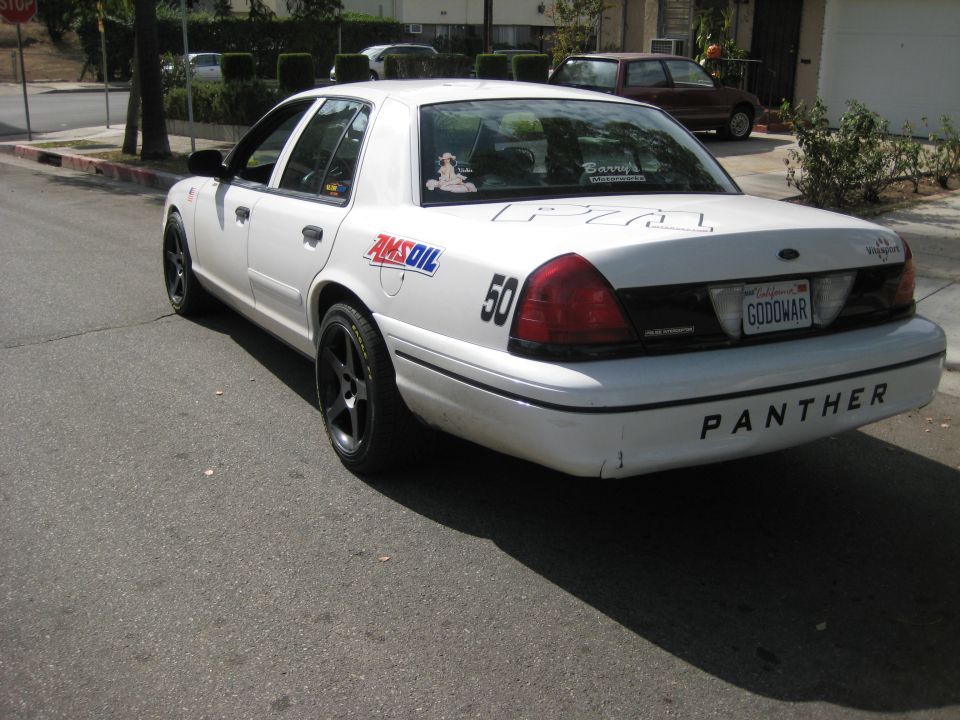 White 2001 Ford Crown Victoria rear view with 'PANTHER' on bumper