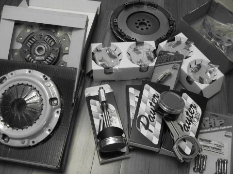 1994 Ford Probe - A collection of engine components, including Pauter connecting rods and ARP fasteners, are laid out on a wooden floor.