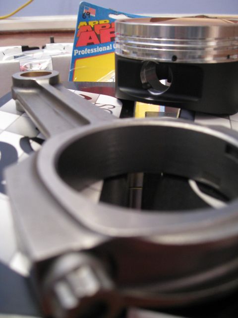 1994 Ford Probe - Close-up of engine components, including a connecting rod and piston, with a gasket box visible.