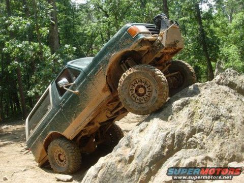 1990 Ford Bronco - This 1990 Ford Bronco is navigating a difficult rocky obstacle on an off-road trail.