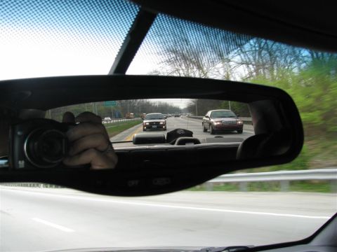 2003 Mercury Marauder - A red 2003 Mercury Marauder is seen in the rearview mirror while driving on a highway.