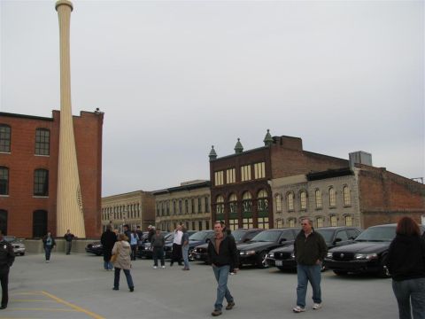 2003 Mercury Marauder - A gathering of 2003 Mercury Marauders in a parking lot, with a prominent baseball bat sculpture in the background.