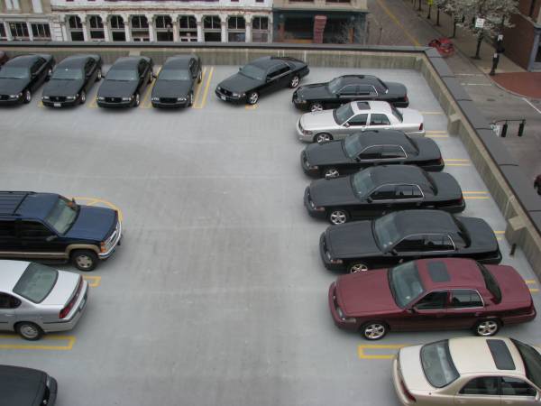 Overhead view of cars parked in a rooftop parking lot