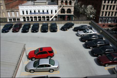 2003 Mercury Marauder - A collection of vehicles are parked on a rooftop lot with buildings in the background.
