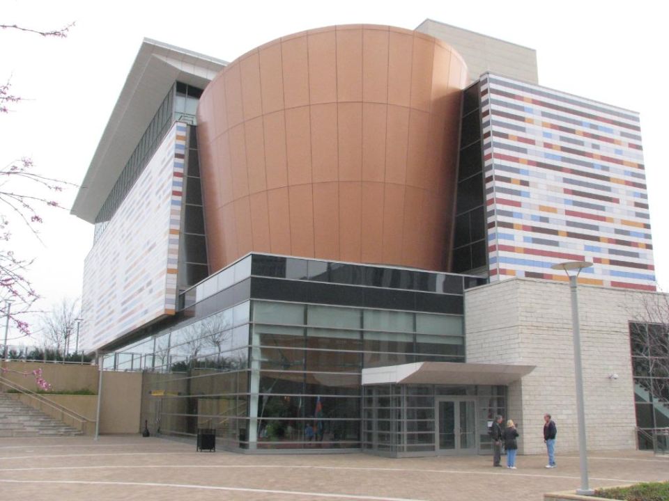 Modern museum building with copper-clad rotunda facade