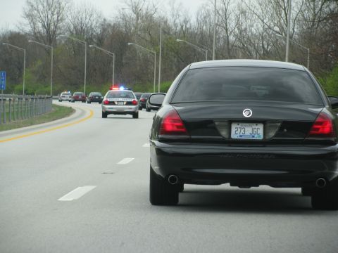 2003 Mercury Marauder - A black 2003 Mercury Marauder is seen on the highway, followed by a police car and other vehicles.
