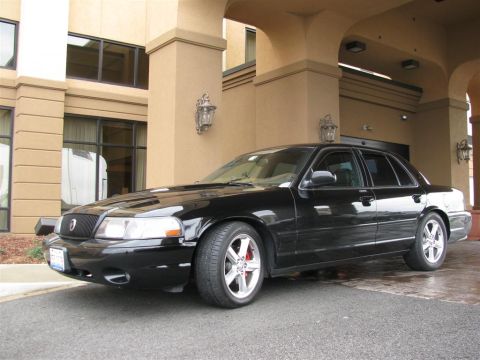 2003 Mercury Marauder - A black 2003 Mercury Marauder is parked in front of a building with an arched entryway.
