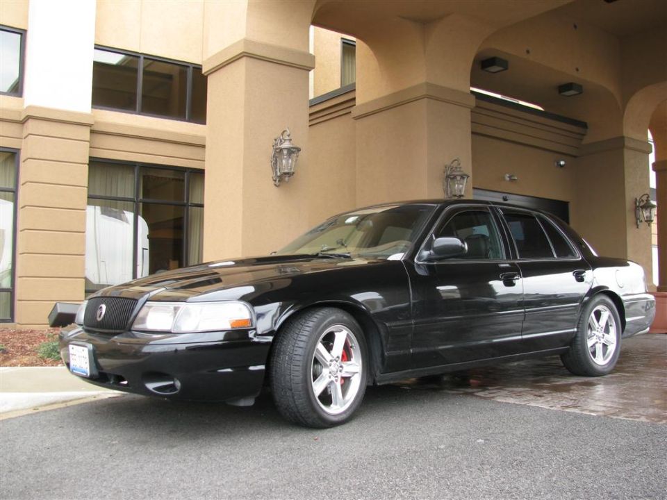 Black 2003 Mercury Marauder parked under a hotel awning