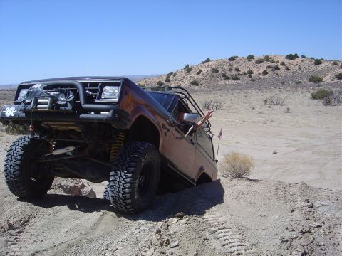 1986 Ford Bronco II - This modified 1986 Ford Bronco II navigates rough terrain with its lifted suspension and oversized tires.