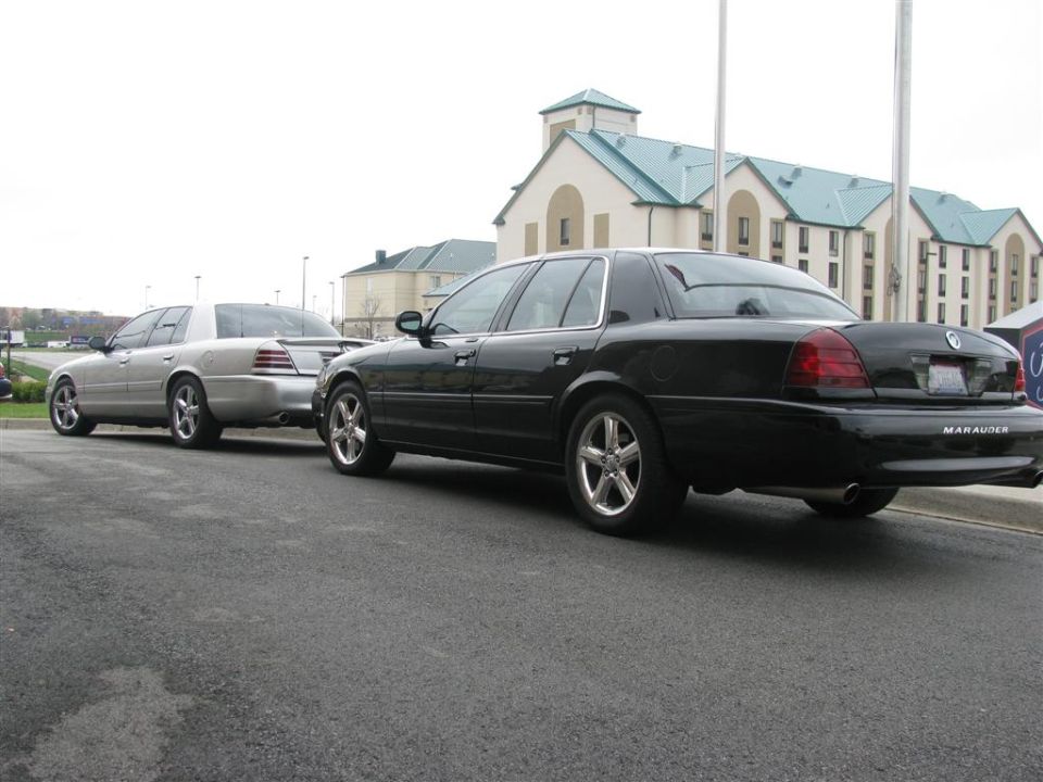 Black 2003 Mercury Marauder parked behind a silver one, rear view