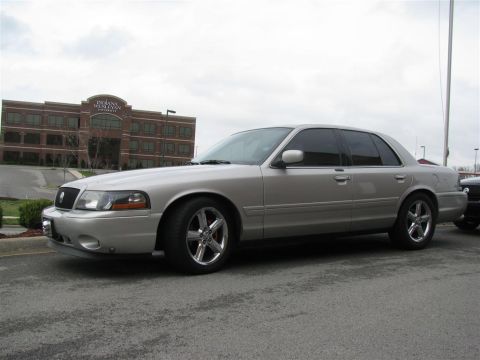 2003 Mercury Marauder - A silver 2003 Mercury Marauder is parked in front of a large brick office building.
