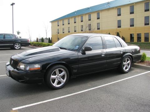 2003 Mercury Marauder - A black 2003 Mercury Marauder with a prominent hood scoop is parked in a lot.
