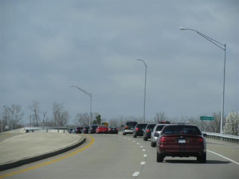 2003 Mercury Marauder - A line of vehicles travels down a highway under a cloudy sky.